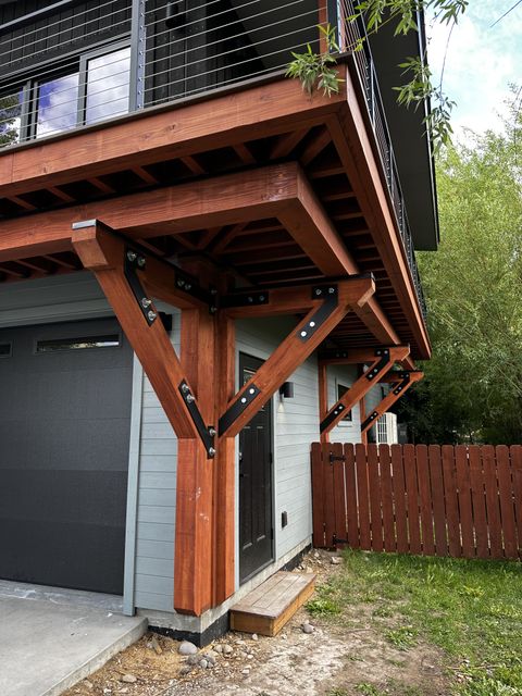 Heavy timber brackets supporting a cable-rail deck above a garage