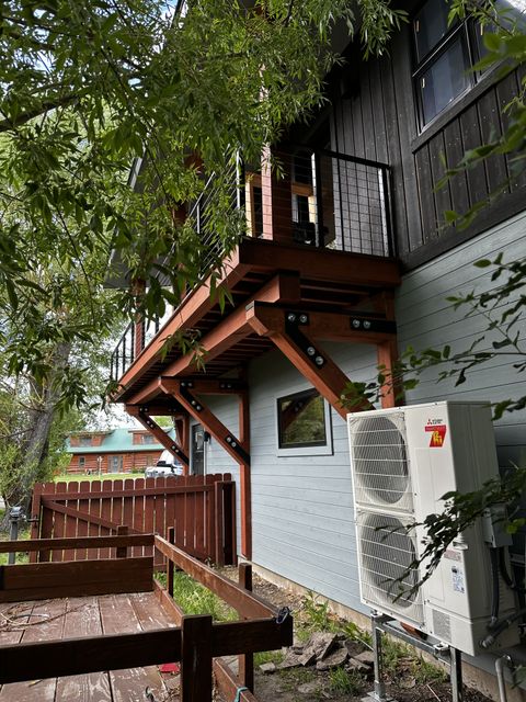 Deck and stairs nestled among mature trees