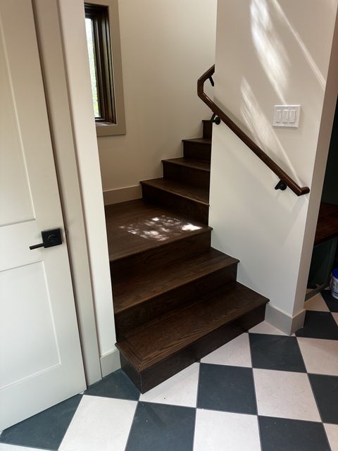Stair landing over black-and-white checkered tile