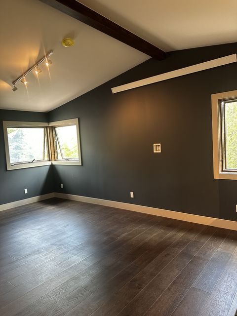 Living room with charcoal accent walls and corner windows