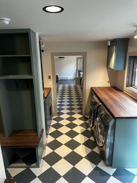 Mudroom with built-in cubbies and checkered floor